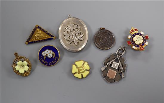 A Victorian silver locket and a silver rifle medal, enamel badges, etc.